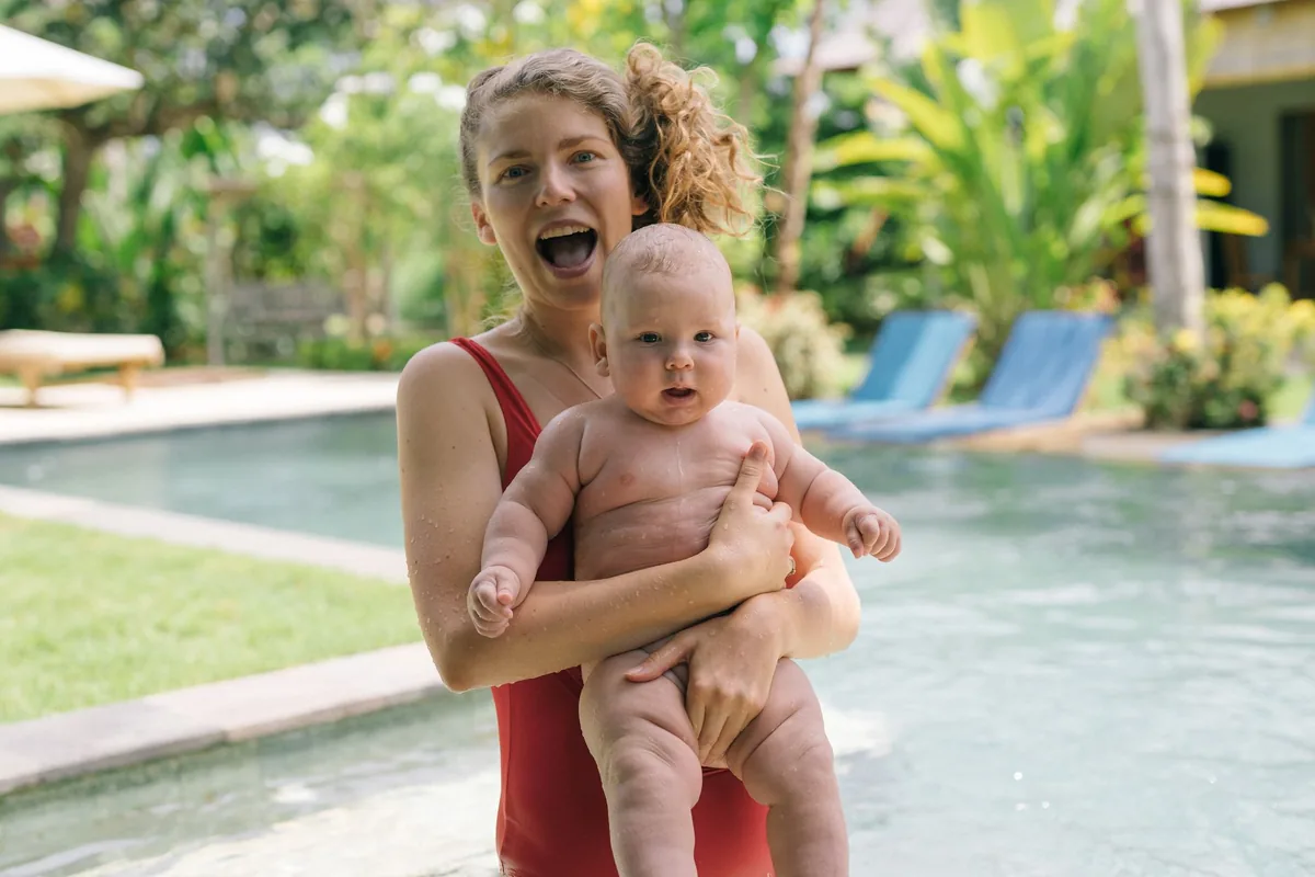 Joyful mother and baby enjoying a fun day by the pool