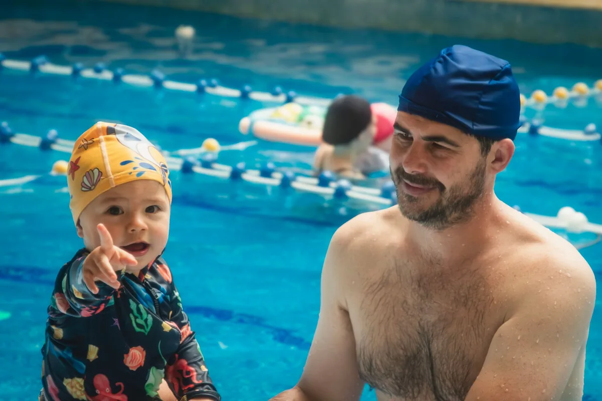 Father and child bond during a swimming lesson at an indoor pool